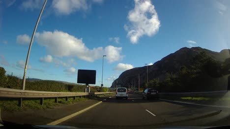 POV-driving-A55-motorway-through-Anglesey-countryside-traffic-on-journey-home