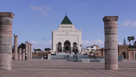 Mausoleum-of-Mohammed-V-in-Rabat,-an-Islamic-monument-blending-history-and-religion,-outdoor-tower-view-with-pillars-on-the-sides