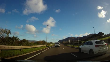 POV-driving-A55-motorway-through-rural-Wales-countryside-traffic-on-journey-home
