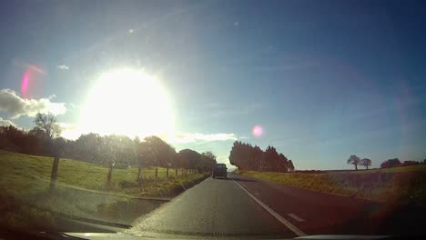 POV-driving-A55-motorway-through-rural-Anglesey-countryside-traffic-on-journey-home-at-sunrise
