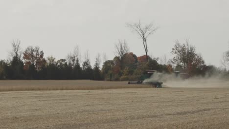 Agricultural-Tractor-Harvesting-On-The-Field-With-Dust-In-Autumn