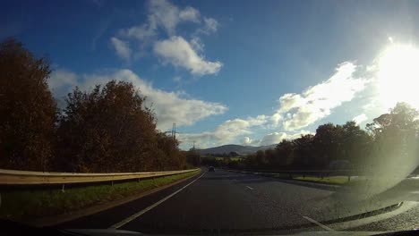 POV-driving-A55-highway-through-rural-Anglesey-countryside-traffic-on-journey-home
