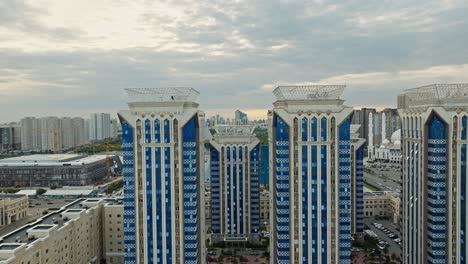 An-Urban-Landscape-with-Towering-Structures-in-Astana,-Kazakhstan---Aerial-Pan-Up