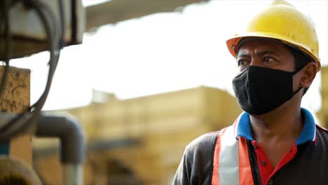 Professional-worker-or-machine-operator-controls-the-machine-by-pressing-buttons-and-turning-the-tap-in-the-Asphalt-Mixing-Plant-factory