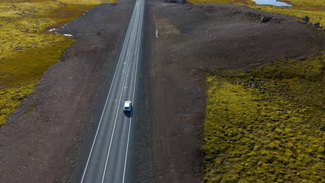 Aerial-tracking-shot-of-a-car-traveling-across-Iceland-visiting-tourist-spots
