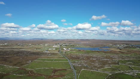 Flyover-of-Banraghbaun-South-countryside-with-fluffy-clouds-in-the-sky