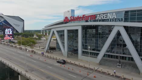 Ascending-drone-shot-showing-State-Farm-Arena,-Mercedes-Benz-Stadium-and-Signia-Hilton-Hotel-in-background---Atlanta-City,-Georgia