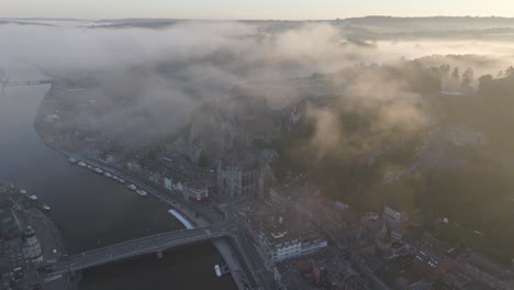 Notre-Dame-cathedral-in-Belgium-at-Dinant-city-during-sunrise,-aerial