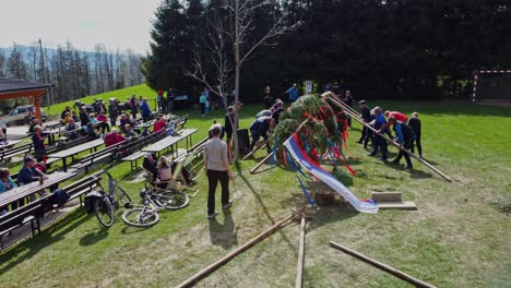 "Mlaj"-maypole-on-the-ground-with-the-Slovenia-flag