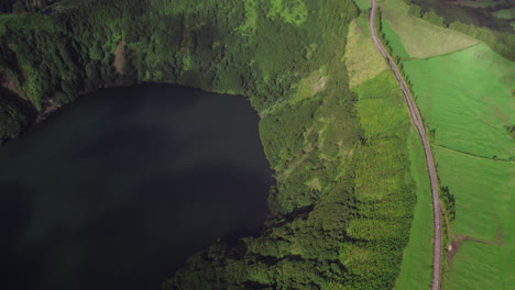 Lagoa-de-Santiago,-green-terrain,-and-winding-road,-São-Miguel,-Azores