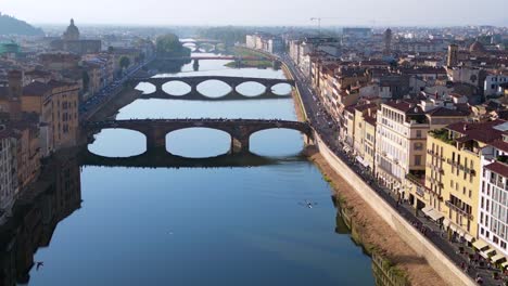 Stunning-aerial-top-view-flight-medieval-bridge-town-Florence-river-Tuscany-Italy