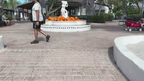 Orange-pumpkins-filled-the-water-fountain-at-Seaport-Village-Downtown-San-Diego-with-tourists-photographing
