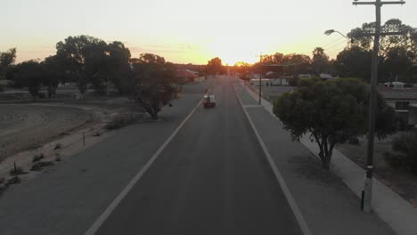 Pick-up-truck-drives-on-road-at-Carnamah-western-Australia,-aerial