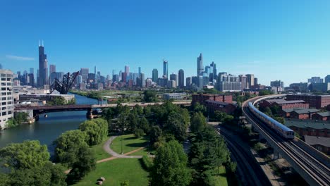 Elevated-Train-Passes-Over-City-Park-Chicago-Downtown-Skyline