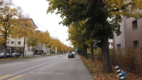 Streets-of-Bern-Switzerland-during-Autumn,-Trees-Leaves-Cars-and-Bicycles