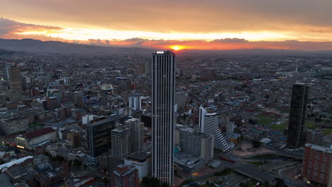Aerial-tracking-shot-overlooking-the-cityscape-of-Bogota,-sunny-evening-in-Colombia