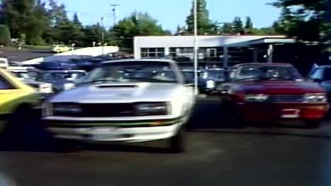 Driving-by-a-Ford-dealership-cars-for-sale-in-1970s