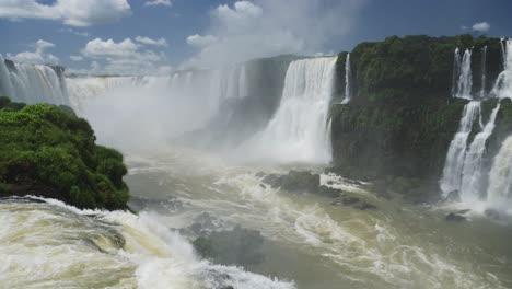 Dramatic-Waves-Crashing-into-Rocky-Pool-Floor-From-Huge-Waterfall-Valley,-Slow-Motion-Picturesque-View-of-Amazing-Rocky-Cliff-Edge-Landscape-in-Iguazu-Fall,-Argentinian-Destination,-South-America