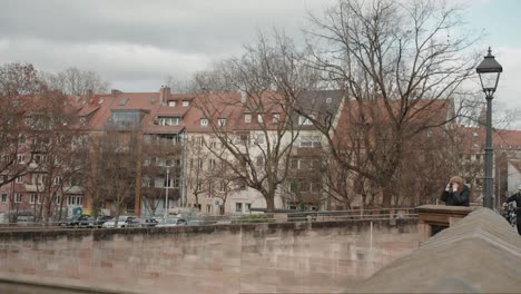 Woman-tourist-photographing-in-Nuremberg's-Alstadt-oldtown,-Germany