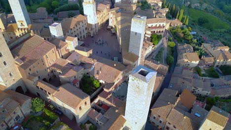 Smooth-aerial-top-view-flight-walled-medieval-hill-tower-Town-Tuscany-Italy-San-Gimignano
