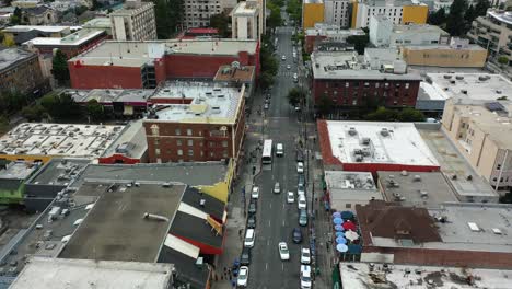 Aerial-view-flying-over-traffic-on-streets-of-Berkeley,-cloudy-day-in-California