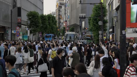 Ambulance-driving-over-Shibuya-Crossing-Tokyo-Japan,-Crowd-of-people