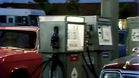 GAS-PUMP-CU-WITH-ZOOM-OUT-TO-LINE-OF-CARS-FROM-1970S