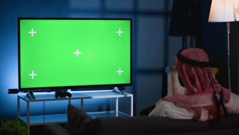 Man-watching-green-screen-TV