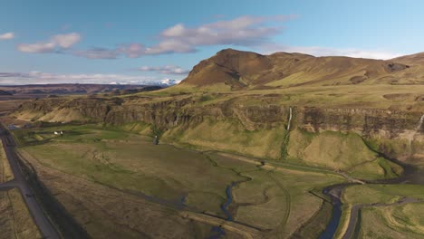 Panoramic-aerial-view-of-scenic-waterfall-landscape-with-the-view-of-Icelandic-plateau,-mountain-peak-and-valley,-Iceland,-Drone-Shot