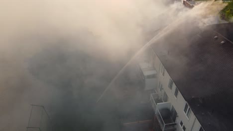 Firefighters-extinguish-a-residential-fire-spread-throughout-rooftop
