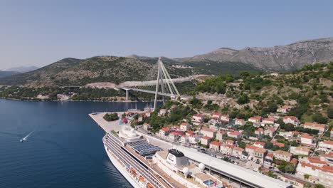 Docked-cruise-ship-and-the-Franjo-Tuđman-Bridge-in-Dubrovnik,-aerial-view