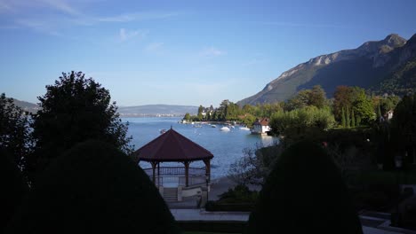 Gazebo-and-other-lake-shore-structures-in-Lake-Annecy-in-the-French-Alps,-Locked-shot