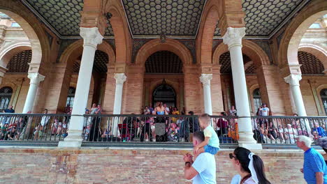Slow-motion-shot-of-tourists-watching-a-show-outside-of-historical-most-famous-landmark-Plaza-España,-Sevilla-in-Spain,-Europe