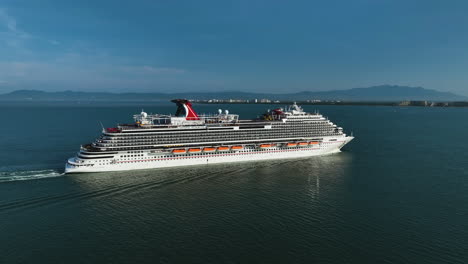 Aerial-pan-shot-following-a-large-luxury-voyager-on-the-coast-of-sunny-Mexico