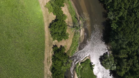 Top-Down-View-Of-River-Flowing-Through-Lush-Forest-In-Oronoco,-Minnesota,-USA---drone-shot