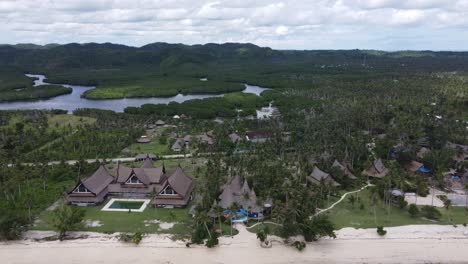 Luxurious-traditional-cabana-huts-of-Nay-Palad-hideout-beachfront-resorts-on-tropical-Siargao-island