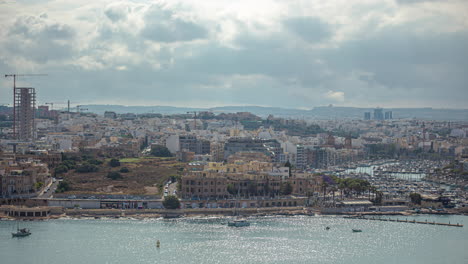 Un-Gran-Paisaje-Urbano-En-La-Costa-Y-Barcos-Blancos-Navegando-En-El-Mar-En-Malta