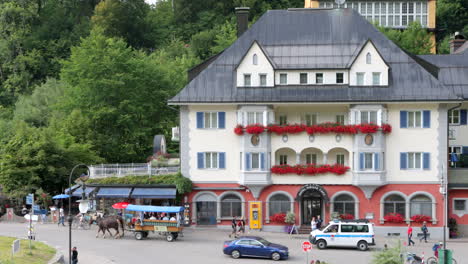 Exterior-Facade-Of-Typical-Bavarian-Hotel-Decorated-With-Red-Flowers-In-Schwangau,-Germany