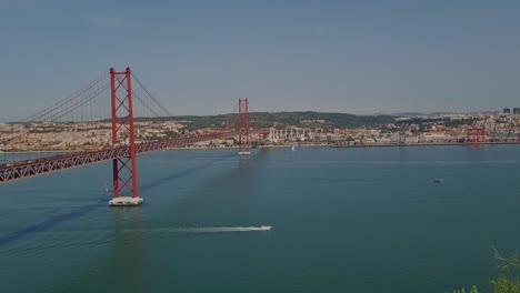 Panoramic-view-of-the-25th-April-Bridge-on-a-bright-and-sunny-day-in-Lisbon,-Portugal
