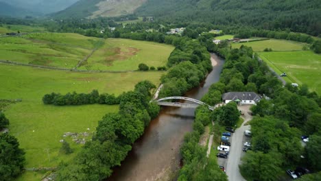 Aerial-Drone-footage-of-the-a-river-Nevis-centre-bridge-at-the-start-of-the-Ben-Nevis-climb,-highlands,-Scotland