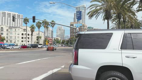 On-street-crossing-Downtown-San-Diego-and-rat-rod-car-passes-with-Ford-Mustang-and-restored-Policia-Federal-waits