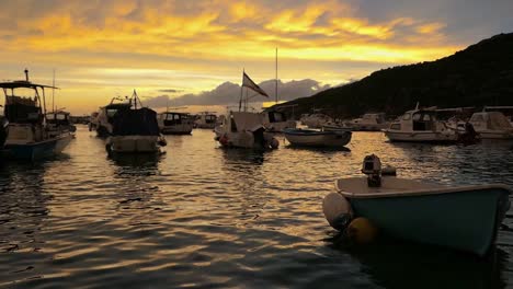 Sunset-and-docked-boats-at-Mediterranean-island,-Komiza,-Vis,-Croatia