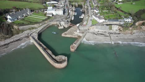 Cinematic-reveal-of-Charlestown-historic-port-with-old-tall-ships,-UNESCO-heritage-site