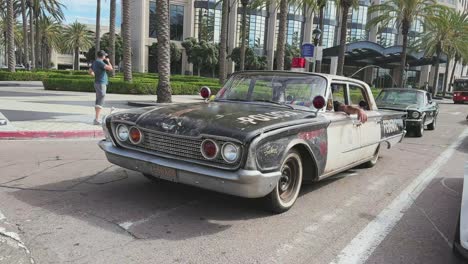 Hot-rods,-a-Ford-Mustang,-Police-Federal-car-and-others-waiting-on-green-light-in-Downtown-street-in-San-Diego