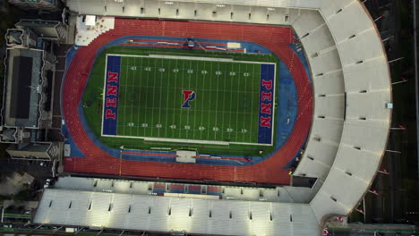 Top-down-drone-shot-rising-above-the-Franklin-Field,-sunny-evening-in-Philadelphia