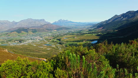 Sweeping-top-view-over-lush-wine-growing-valley-of-Franschhoek,-South-Africa