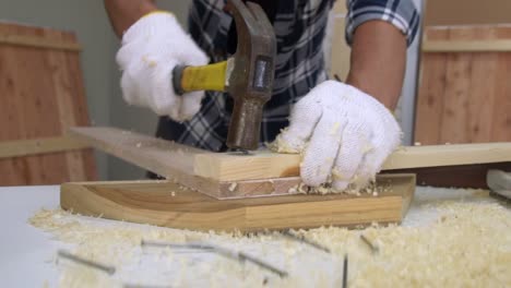 Carpenter-working-on-wood-craft-at-workshop