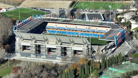 Aerial-sweep-over-la-Mosson:-Montpellier's-stadium-stands-proud,-neighbored-by-t
