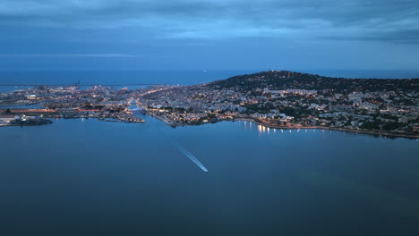Drone's-view:-Nighttime-Sète,-coastal-allure,-maritime-traditions,-and-vibrant