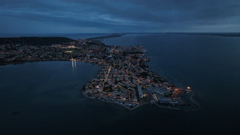 Aerial-night-exploration:-Sète's-cultural-hub,-bustling-markets,-and-maritime-he
